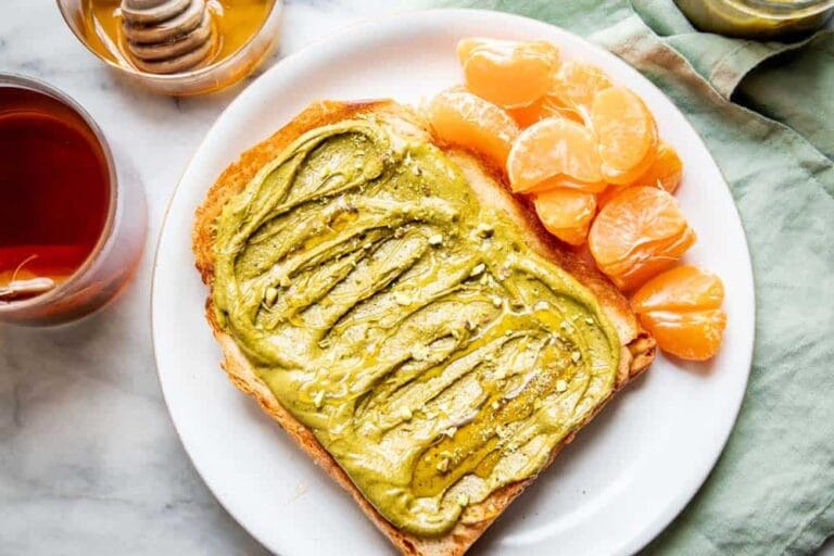 homemade pistachio butter in jar on rustic table